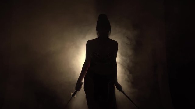 a warrior girl with a dark long ponytail and bangs stands alone in a dark room with smoke and dim light, slowly turns liu to the camera and gracefully, proudly meets. true samurai image