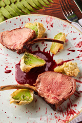 Roasted lamb ribs with berry sauce and broccoli