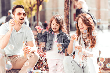 Happy family in summer park having fun
