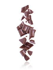 Broken porous dark chocolate fall down on white background