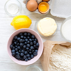 Raw ingredients for cooking blueberry pie. Overhead, flat lay. Closeup.