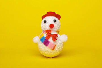 Christmas, New Year's snowman on a yellow background. Christmas background