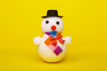 Christmas, New Year's snowman on a yellow background. Christmas background