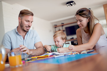 Parents draw with a little son
