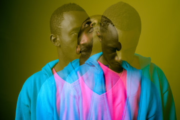 Double exposure shot of young African man against green background