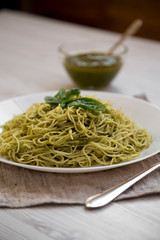 Plate of pasta spaghetti with pesto sauce, close-up.