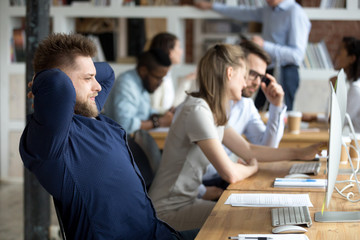 Smiling satisfied businessman relaxing leaning back in office chair with hands over head, happy employee after finish difficult work, receiving, reading good news, looking at screen, taking break
