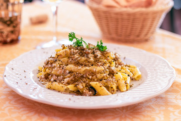 Dish of classic Italian pasta with black truffle and sheep cheese and olive oil. Selective focus, close-up.
