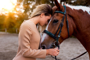 Young beautiful woman with a horse