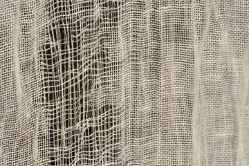 Woven linen, ripped, backlighted. Tear to the left. Tissues, curtain. Natural.