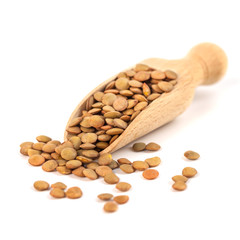 dry lentils on wooden spoon isolated on a white background