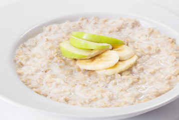 bowl with oatmeal and fruits isolated on white background