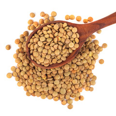 dry lentils on wooden spoon isolated on a white background