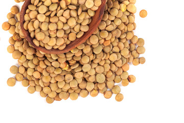 dry lentils on wooden spoon isolated on a white background