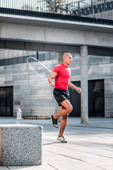 Nice good looking man holding a skipping rope