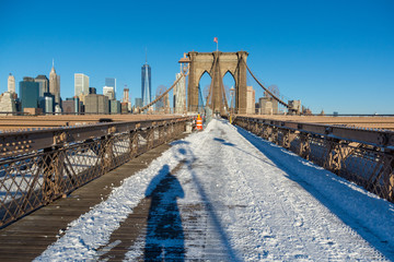 Brooklyn Bridge, New York on a sunny winter day with blue sky and detail of stone and steel work