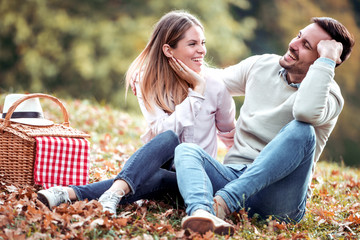 Couple in love sitting in autumn park