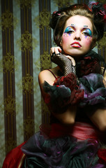 Fashion shot of woman in doll style. Creative make-up.