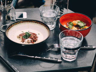 Meat tartar on wooden table in cafe street