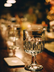 Bar stand with bottles of alcohol in dark
