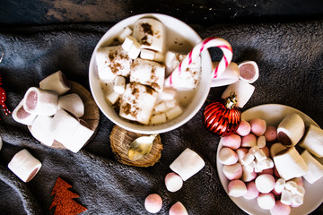 Good New Year spirit. Coffee with marshmallows and cinnamon. Candy canes. Pink mug. Cooking yourself. Home comfort. New Year. Christmas time. Winter mood.