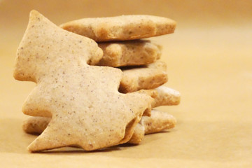 Christmas gingerbread cookies with one in shape of Christmas tree in the front