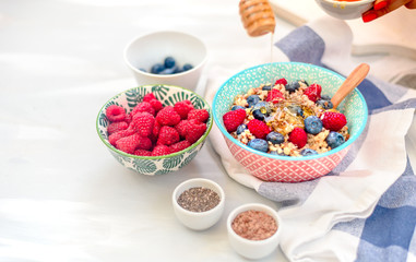 High protein healthy breakfast, buckwheat porridge with blueberries, raspberries, flax seeds and honey Closeup view, selective focus
