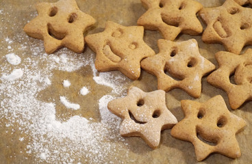 Smile face gingerbread cookies in star shape, Christmas aromatic and spiced cookies