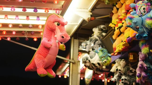Pink dragon soft toy prize at fairground game. Haliburton, Ontario.