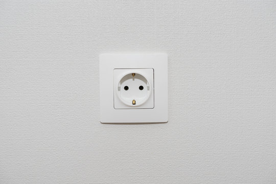 Alone outlet Electrical Socket on white baskgrounds.  copy space for text , renovation , new home ownership concept