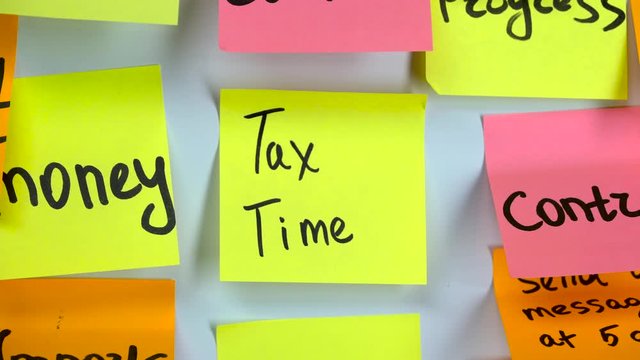 Sticker with the words tax time on a whiteboard