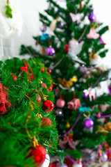 Fototapeta na wymiar Christmas decorations adorn the fir-tree branches on the Christmas tree.