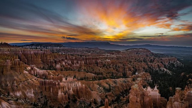 4k Timelapse movie film clip of Bryce Canyon sunrise sunset with clouds and pink sky during twilight with shadows moving across the landscape of bryce canyon in utah in summer with snow on the ground