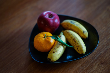 Fruits in a bowl on a wooden table