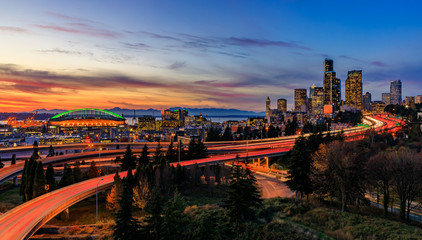 Seattle downtown skyline panorama at sunset from Dr. Jose Rizal or 12th Avenue South Bridge with traffic trail lights