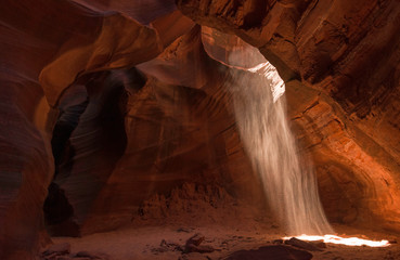 Sand streams down into the Grotto in Cardiac Canyon, Navajo reservation, Arizona
