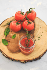 Tomato sauce with fresh tomatoes and basil on wooden table