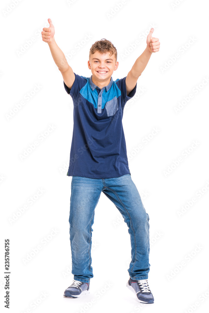 Wall mural Full length portrait of young caucasian teen boy isolated on white background. Funny teenager making thumb up gesture. Handsome child looking at camera and smiling.