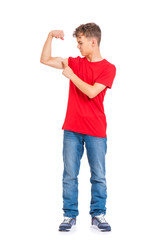 Full length portrait of young caucasian teen boy isolated on white background. Funny teenager wearing red t-shirt showing off his biceps. Handsome child showing his hand biceps muscles strength.