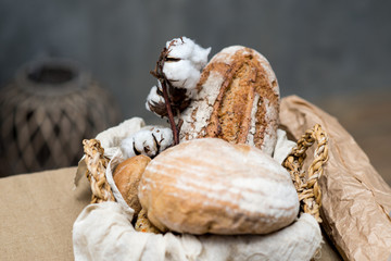 Composition with variety of baking products in the basket on the table.