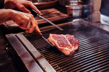 Close-up image of a cooking delicious meat steak on a grill