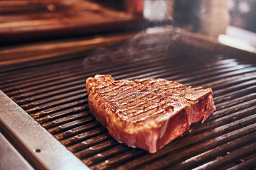 Close-up photo of roasted juicy steak on the grill
