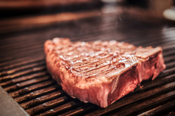 Close-up photo of roasted juicy steak on the grill