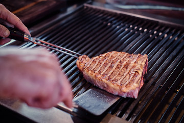 Close-up image of a cooking delicious meat steak on a grill
