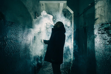 Vape man silhouette. E-cigarette smoker vaping and exhales cloud of steam or vapor