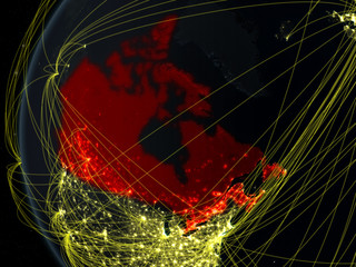 Canada from space on model of Earth at night with international network. Concept of digital communication or travel.