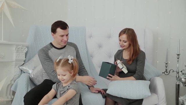 A family of three sitting on the couch and talking on New Year's Eve, Christmas 2019.