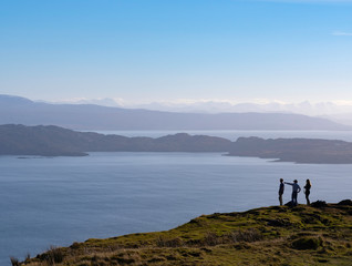 Fototapeta na wymiar Hikers view the Sound of Raasay from Trotternish, Isle of Skye, Scotland