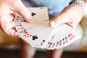 Magician hands doing magic trick with playing cards.