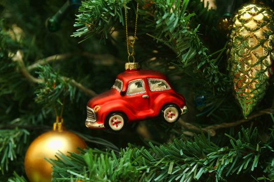 Red car toy, cone and ball on Christmas tree